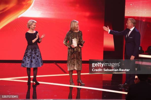 Ursula von der Leyen and Johannes B. Kerner present Jutta Speidel with the 'Das Goldene Herz' award on stage at the "Ein Herz Für Kinder" Gala at...