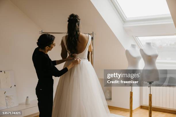 young bride trying wedding dress with her tailor - dress form stock pictures, royalty-free photos & images