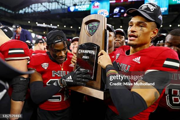 Northern Illinois Huslies players celebrate after defeating the Kent State Golden Flashes, 41-23, to win the 2021 MAC Championship at Ford Field on...