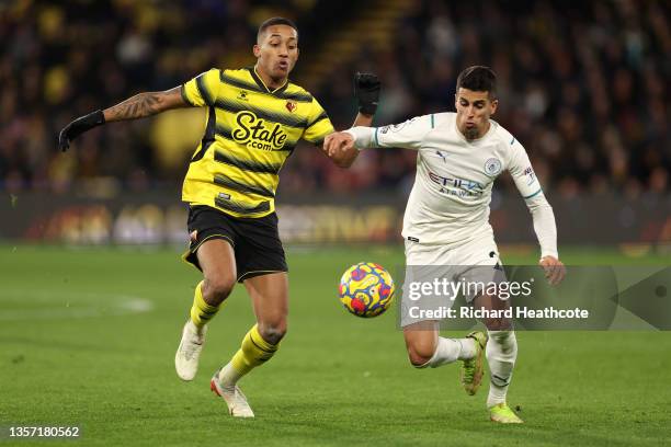 Joao Pedro of Watford FC battles for possession with Joao Cancelo of Manchester City during the Premier League match between Watford and Manchester...