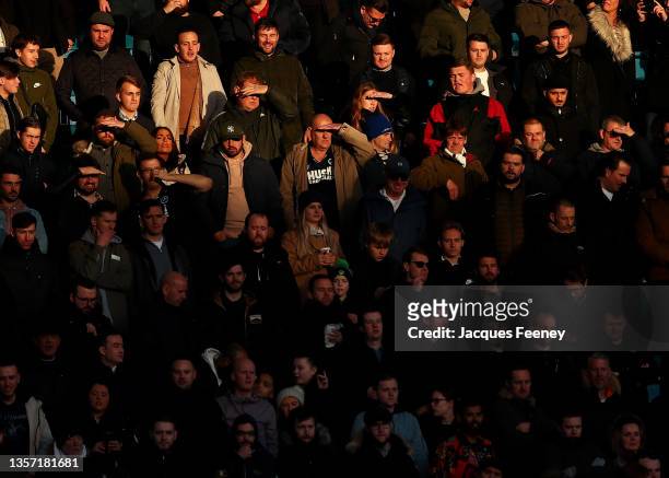 Fans watch on during the Sky Bet Championship match between Millwall and Birmingham City at The Den on December 04, 2021 in London, England.