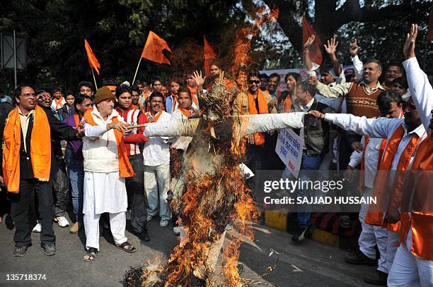 Indian Hindu nationalist party Shiv Sena activists shout slogans as they burn an effigy of Mohammed Afzal Guru, who has been sentenced to death for...