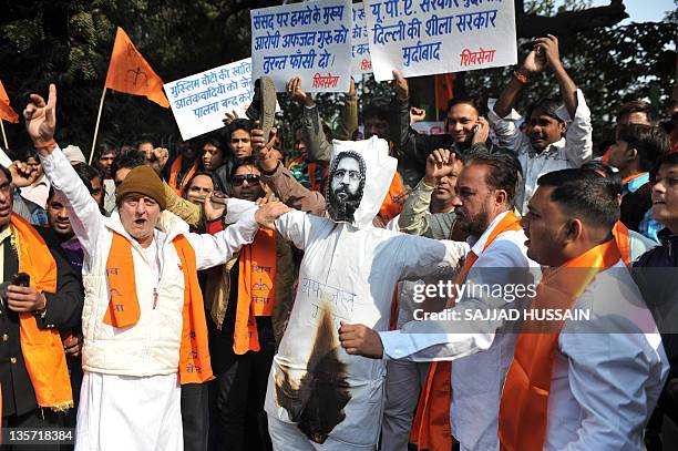 Indian Hindu nationalist party Shiv Sena activists shout slogans as they set fire to an effigy of Mohammed Afzal Guru, who has been sentenced to...