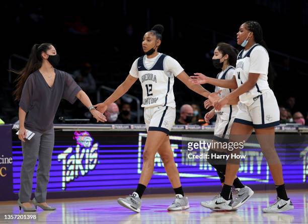 Judea Watkins of Sierra Canyon celebrates as she leaves the court with head coach Alicia Kreutner, Christy Reynoso and Mackenly Randolph during the...