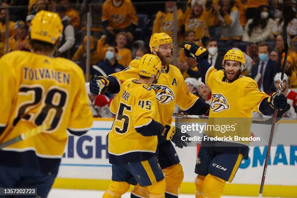 Eeli Tolvanen of the Nashville Predators watches as teammates Alexandre Carrier, Mattias Ekholm and Luke Kunin celebrate his goal against the...