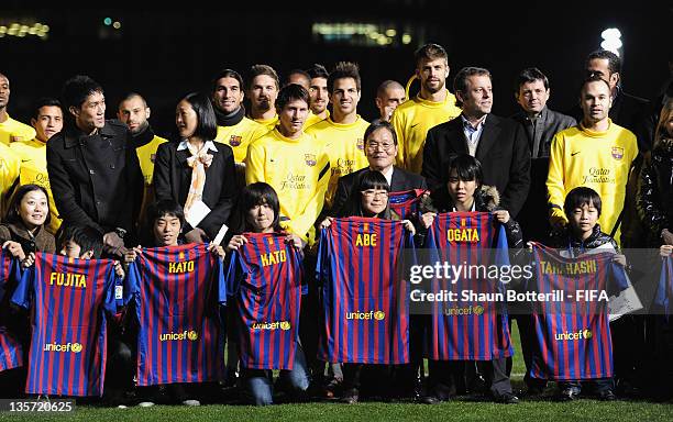 Lionel Messi and Cesc Fabregas and other Barcelona players pose with children orphaned in the Great North East Japan Earthquake during the Barcelona...