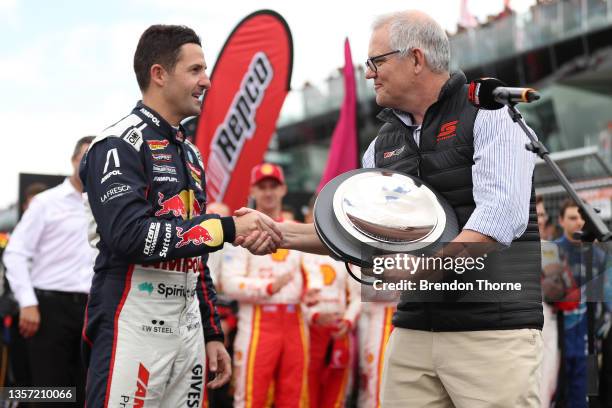 Jamie Whincup driver of the Red Bull Ampol Racing Holden Commodore ZB poses with Australian Prime Minister Scott Morrison after being inducted into...