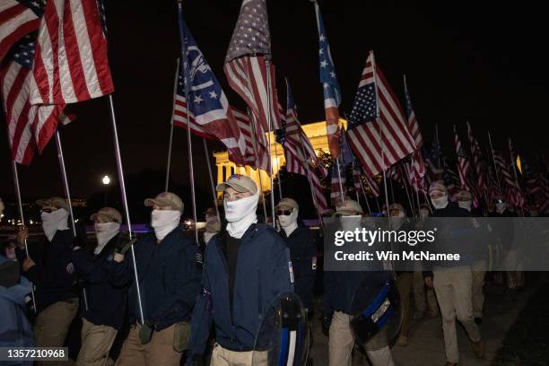 Members of the rightwing group Patriot Front march across Memorial Bridge in front of the Lincoln Memorial on December 04, 2021 in Washington, DC....