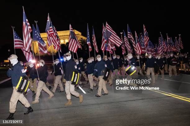 Members of the rightwing group Patriot Front march across Memorial Bridge in front of the Lincoln Memorial on December 04, 2021 in Washington, DC....