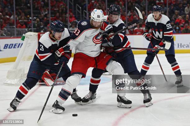 Jakub Voracek of the Columbus Blue Jackets is defended by Nick Jensen and Dmitry Orlov of the Washington Capitals during the third period at Capital...