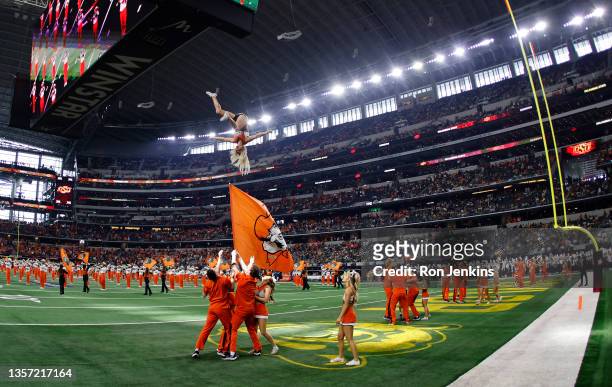 The Oklahoma State Cowboys cheerleaders perform before the game against the Baylor Bears in the Big 12 Football Championship at AT&T Stadium on...