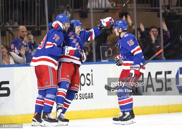 Artemi Panarin of the New York Rangers celebrates his goal with teammates K'Andre Miller and Ryan Strome in the third period against the Chicago...