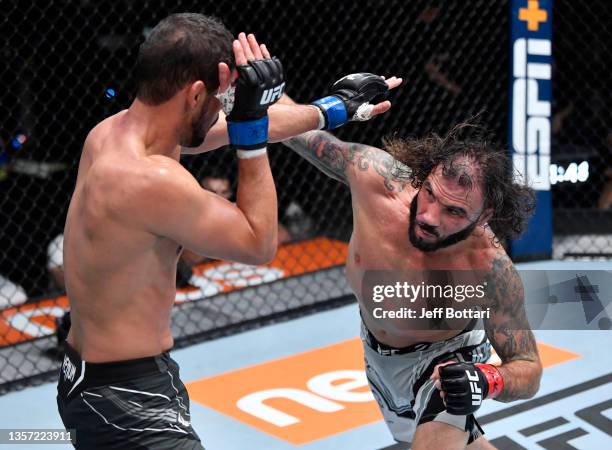 Clay Guida punches Leonardo Santos of Brazil in their lightweight fight during the UFC Fight Night event at UFC APEX on December 04, 2021 in Las...