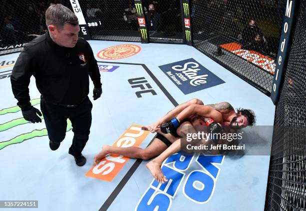 Clay Guida works to secure a submission against Leonardo Santos of Brazil in their lightweight fight during the UFC Fight Night event at UFC APEX on...