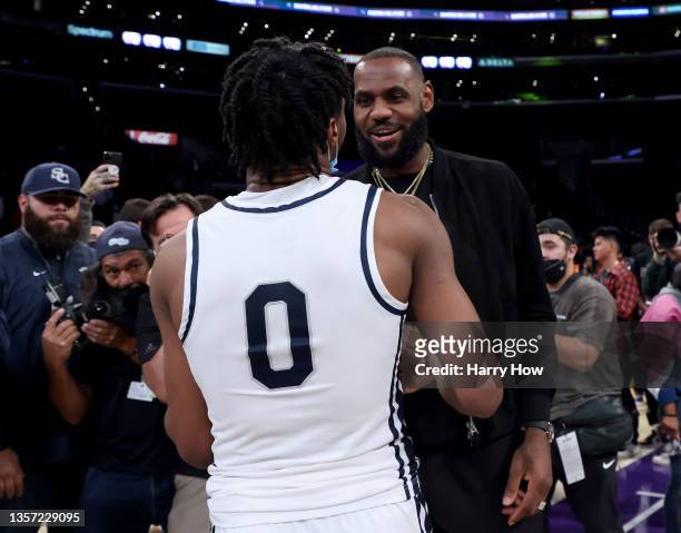 LeBron James of the Los Angeles Lakers talks with his son Bronny James of Sierra Canyon after the game against St. Vincent - St. Mary during The...