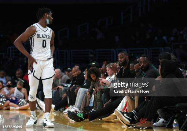 LeBron James of the Los Angeles Lakers speaks to his son Bronny James of Sierra Canyon during the game against St. Vincent - St. Mary during The...
