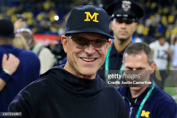 Head coach Jim Harbaugh of the Michigan Wolverines walks on the field after winning the Big Ten Football Championship game against the the Iowa...