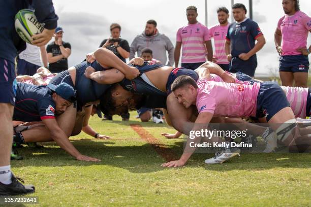 Rebels players perform a scrum drill during a Melbourne Rebels Super Rugby and SuperW joint training session at Moorabbin Rugby Club on December 04,...