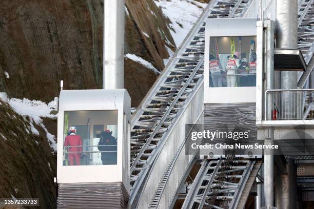 Athletes take elevators during the men's normal hill individual gundersen 10km of FIS Nordic Combined Continental Cup 2021/2022, a test event for the...