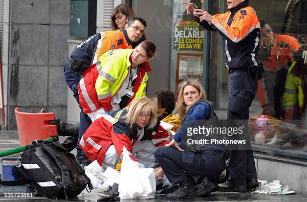 Emergency services assist a victim after a grenade attack at Place St-Lambert in the heart of the city on December 13, 2011 in Liege, Belgium. Two...