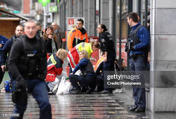 Emergency services assist a victim after a grenade attack at Place St-Lambert in the heart of the city on December 13, 2011 in Liege, Belgium. Two...