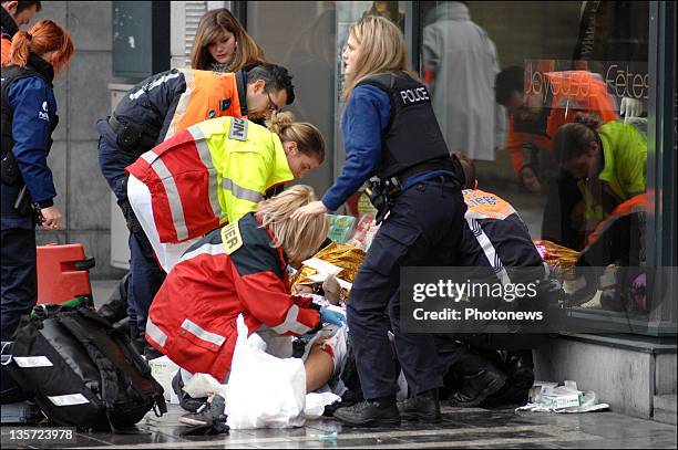 Emergency services assist a victim after a grenade attack at Place St-Lambert in the heart of the city on December 13, 2011 in Liege, Belgium. Two...