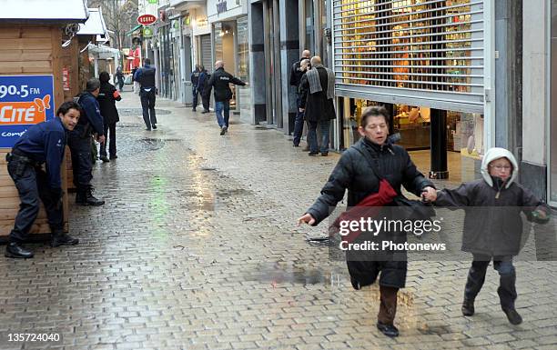 People run as police mobilise after a grenade attack at Place St-Lambert in the heart of the city on December 13, 2011 in Liege, Belgium. Two people...