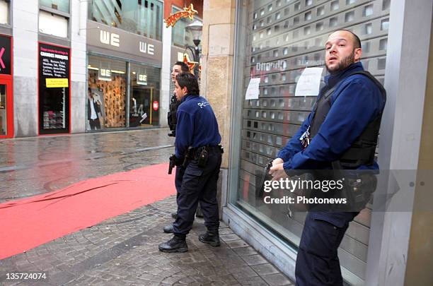 Police unholster guns after a grenade attack at Place St-Lambert in the heart of the city on December 13, 2011 in Liege, Belgium. Two people were...