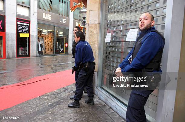 Police unholster guns after a grenade attack at Place St-Lambert in the heart of the city on December 13, 2011 in Liege, Belgium. Two people were...