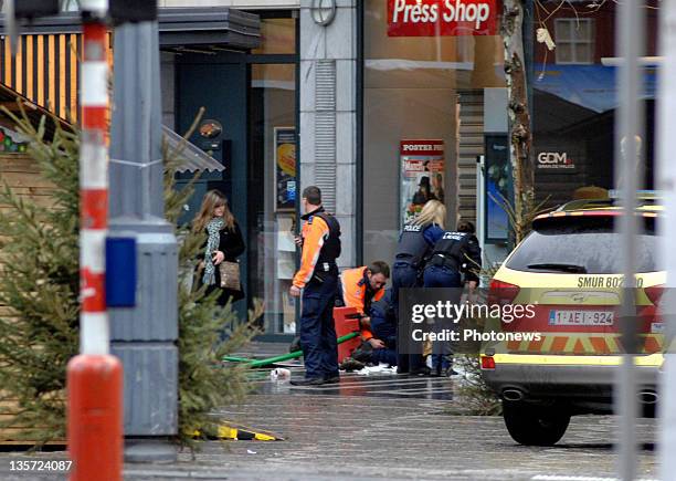 Emergency services assist a victim after a grenade attack at Place St-Lambert in the heart of the city on December 13, 2011 in Liege, Belgium. Two...