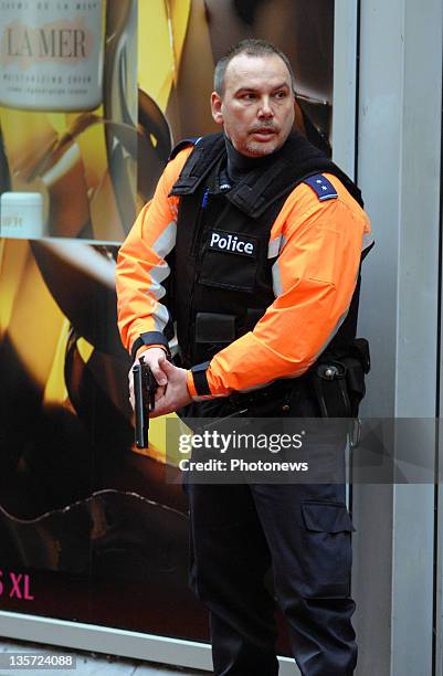 Police unholster guns after a grenade attack at Place St-Lambert in the heart of the city on December 13, 2011 in Liege, Belgium. Two people were...