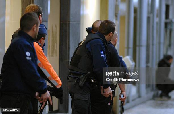 Police unholster their guns after a grenade attack at Place St-Lambert in the heart of the city on December 13, 2011 in Liege, Belgium. Two people...