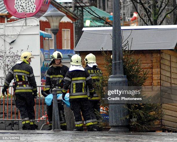 Firemen stretcher off a victim after a grenade attack at Place St-Lambert in the heart of the city on December 13, 2011 in Liege, Belgium. Two people...