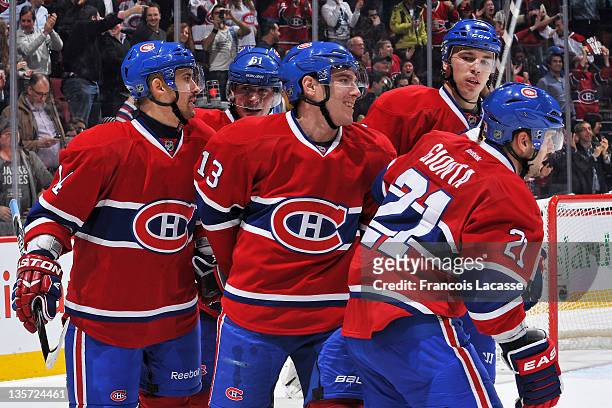 Teammates Tomas Plekanec, Raphael Diaz, Mike Cammalleri, Alexei Emelin and Brian Gionta of the Montreal Canadiens join together to celebrate their...