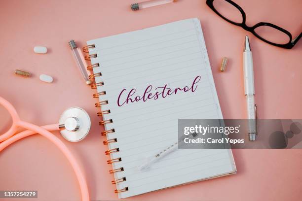 directly above medical desk with the cholesterol message on notepad. - cholesterol stock pictures, royalty-free photos & images