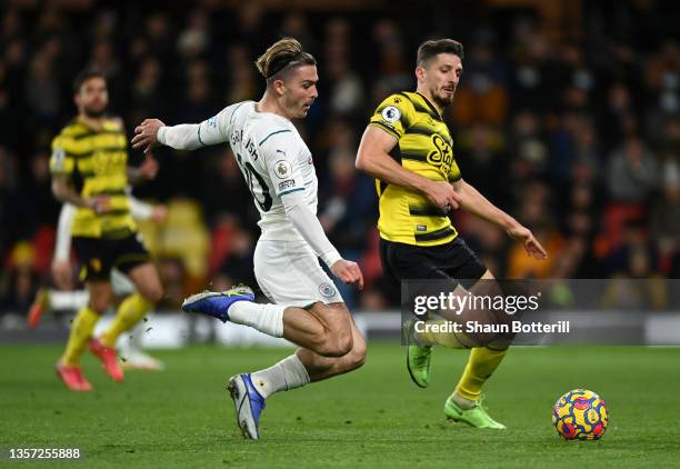 Craig Cathcart of Watford FC band Jack Grealish of Manchester City challenge for the ball during the Premier League match between Watford and...