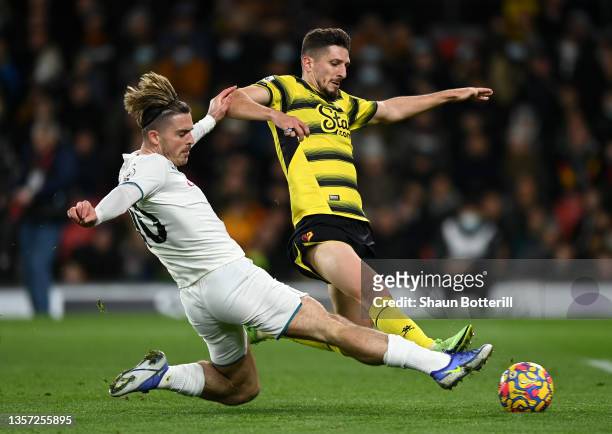 Craig Cathcart of Watford FC band Jack Grealish of Manchester City challenge for the ball during the Premier League match between Watford and...