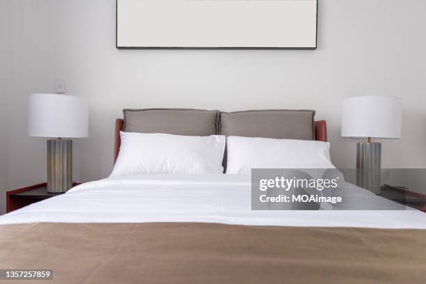 simple and neatly furnished bedroom - letto matrimoniale foto e immagini stock
