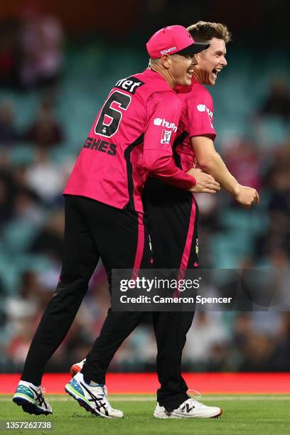 Hayden Kerr of the Sixers celebrates with Daniel Hughes of the Sixers after dismissing Hilton Cartwright of the Stars during the Men's Big Bash...