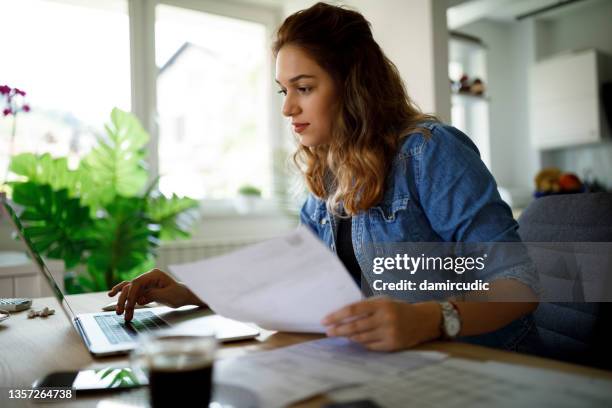 serious young woman working at home - financial freedom stock pictures, royalty-free photos & images