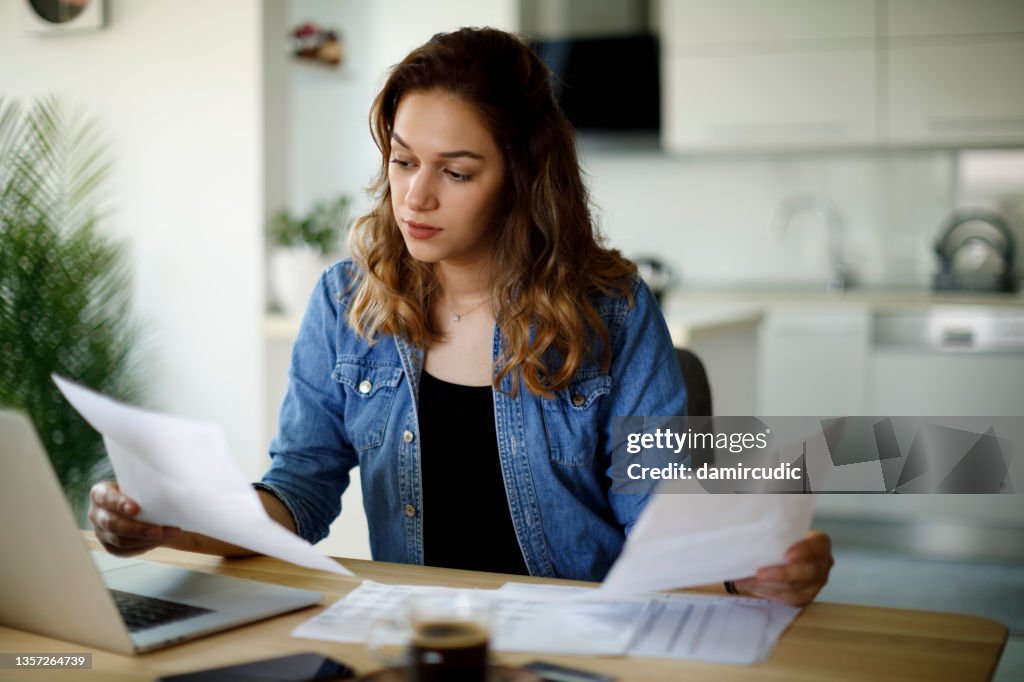 Serious young woman working at home