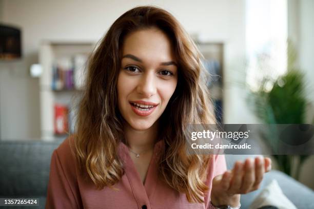 headshot of young smiling woman having video call at home - filmar imagens e fotografias de stock