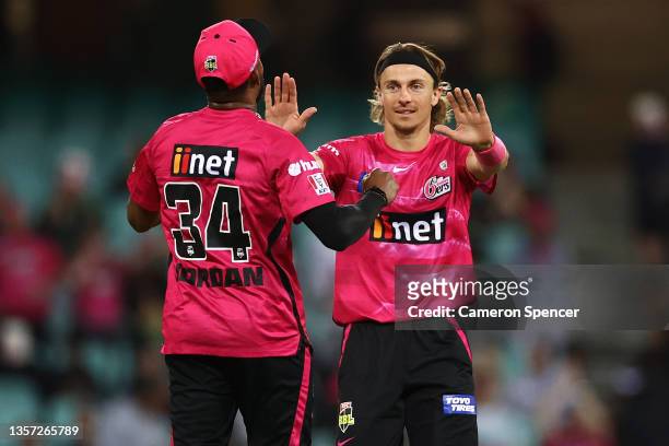 Tom Curran of the Sixers celebrates dismissing Brody Couch of the Stars with Chris Jordan of the Sixers during the Men's Big Bash League match...