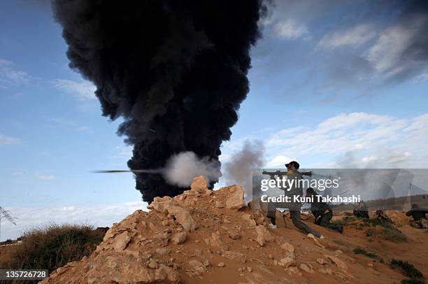 Rebel soldier against Col. Muammar Gaddafi fires an RPG at the frontline March 9, 2011 near Ras Lanuf, Libya. The government military and rebels have...