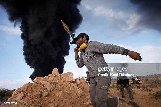 Rebel soldier against Col. Muammar Gaddafi carries an RPG at the frontline March 9, 2011 near Ras Lanuf, Libya. The government military and rebels...