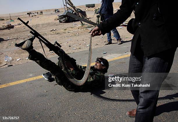 Rebel fighter attempts to shoot down a fighter jet belonging to Col. Muammar Gaddafi's air force March 7, 2011 in Ras Lanuf, Libya.