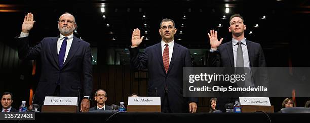 Former MF Global Chairman and CEO Jon Corzine, former President and COO Bradley Abelow and former CFO Henri Steenkamp are sworn in before testifying...