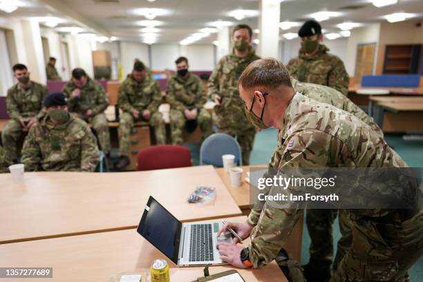 Sergeant Jon Bott from the Royal Lancers briefs his soldiers before they begin welfare visits in remote areas of County Durham still affected by...
