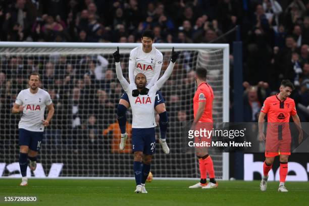 Lucas Moura of Tottenham Hotspur celebrates after scoring their sides first goal with team mate Heung-Min Son during the Premier League match between...