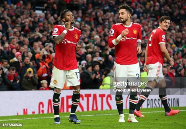 Fred of Manchester United celebrates with Alex Telles after scoring their side's first goal during the Premier League match between Manchester United...